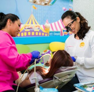 Dr. Jackie Do treating a kid with her staff