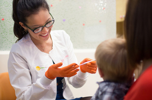 Dr. Jackie Do treating a kid